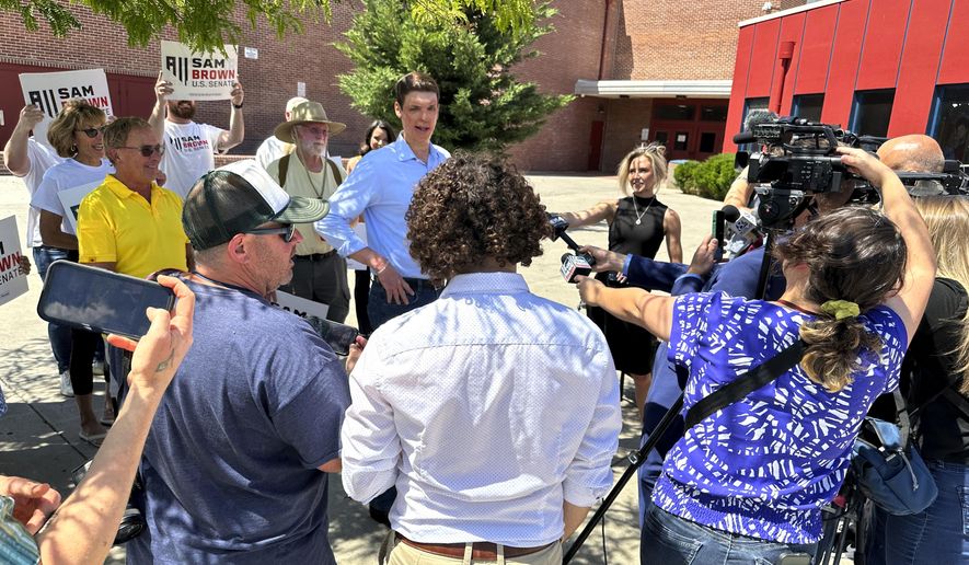Nevada Senate hopeful Sam Brown speaks to reporters outside Reno High School after casting his primary ballot, Tuesday, June 11, 2024, in Reno, Nev. The retired army captain hopes a late endorsement from former President Donald Trump will help carry him to victory in Nevada's GOP U.S. Senate primary and give him the momentum he needs in the general election to help Republicans flip a seat in the closely divided chamber. (AP Photo/Scott Sonner)