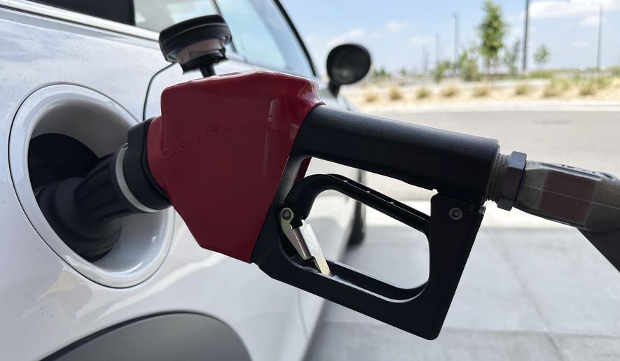 A motorist fills up the tank of a vehicle at a gasoline pump at a Costco warehouse Friday, May 31, 2024, in Aurora, Colo. Gas prices are once again on the decline across the U.S. — bringing some ease to drivers at a time of year when it usually costs a little more to fill up your tank. (AP Photo/David Zalubowski)