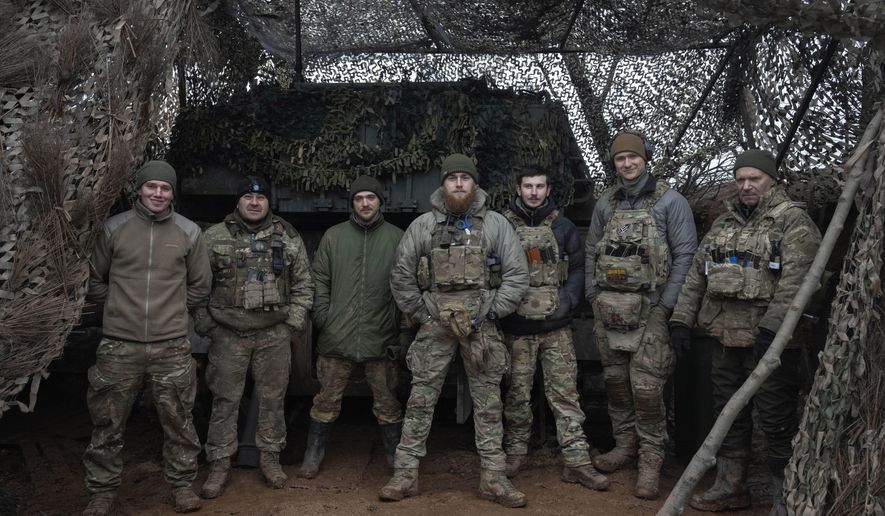 Soldiers of 12th Special Forces Brigade Azov of the National Guard pose for a photo at the 155mm self-propelled gun M109 Paladin at the front line, near Kreminna, Luhansk region, Ukraine, Sunday, Jan. 28, 2024. The U.S. has removed restrictions on the transfer of American weapons and training to a high-profile Ukrainian military unit with a checkered past, the State Department said on Tuesday, June 11, 2024. (AP Photo/Efrem Lukatsky, File)