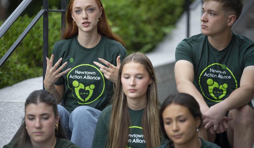 Survivors of the 2012 Sandy Hook Elementary School shooting share their thoughts on high school graduation before a rally against gun violence on Friday, June 7, 2024 in Newtown, Conn. (AP Photo/Bryan Woolston)