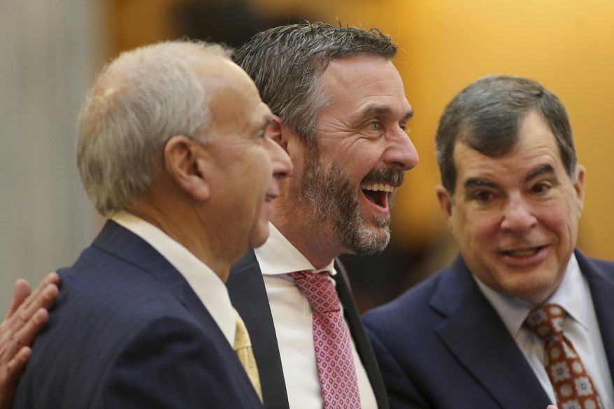 Michael Rulli, center, Ohio Senate Republican from the 33rd District, speaks with colleagues at the Ohio State House Senate Chambers in Columbus, Ohio, Wednesday, Feb. 28, 2024. (AP Photo/Joe Maiorana, File)