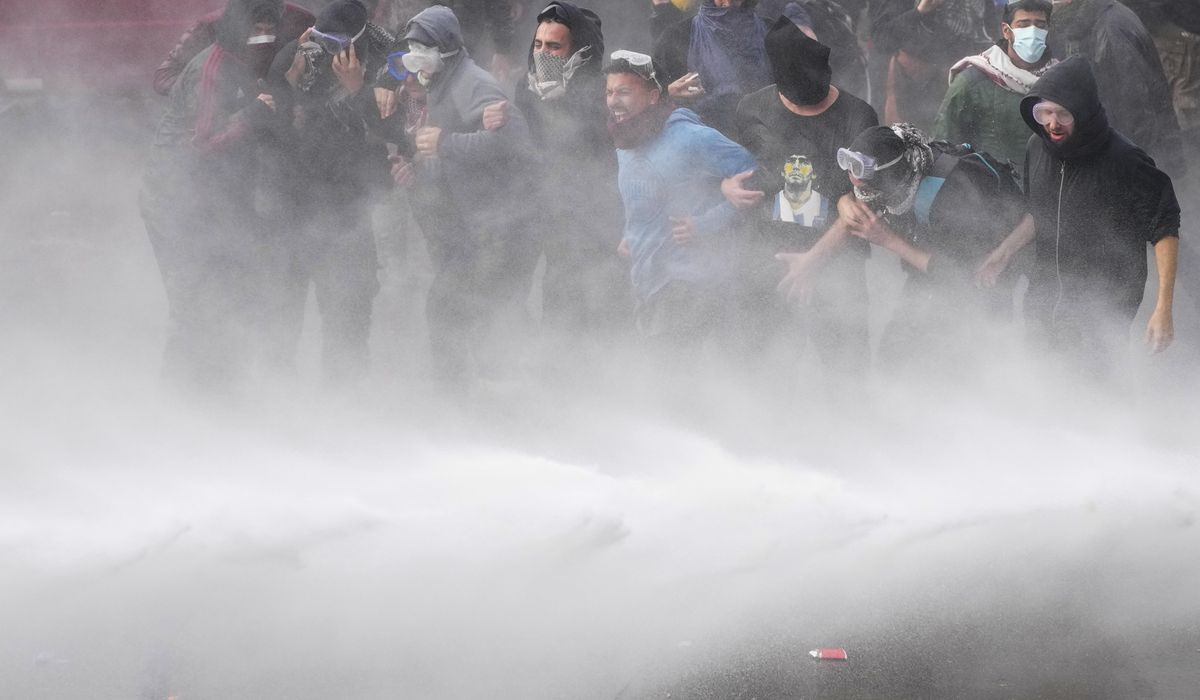 NextImg:Argentine riot police blast protesters with water cannons ahead of key Senate vote