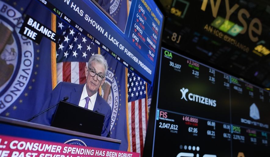FILE - A screen displays a news conference with Federal Reserve Chairman Jerome Powell on the floor at the New York Stock Exchange in New York, May 1, 2024. On Wednesday, June 12, 2024, the Federal Reserve ends its latest meeting by issuing a policy statement, updating its economic and interest-rate projections and holding a news conference with Powell. (AP Photo/Seth Wenig, File)