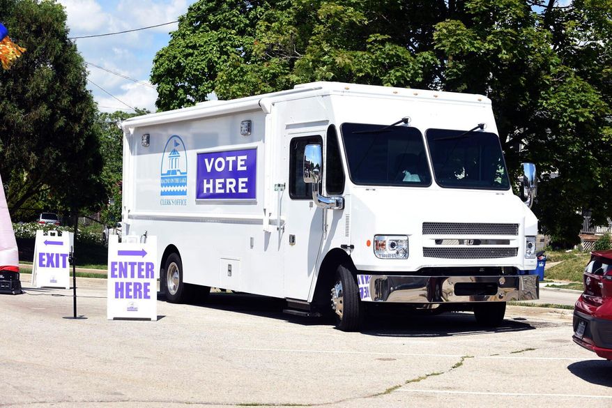 The City of Racine Clerk's Office mobile voting van is seen on July 26, 2022, at the Dr. Martin Luther King Community Center in Racine, Wis. The Wisconsin Supreme Court late Tuesday, June 11, kept in place for now a lower court's ruling banning the use of mobile voting sites in the upcoming presidential election, a win for Republicans. (Ryan Patterson/The Journal Times via AP, File)