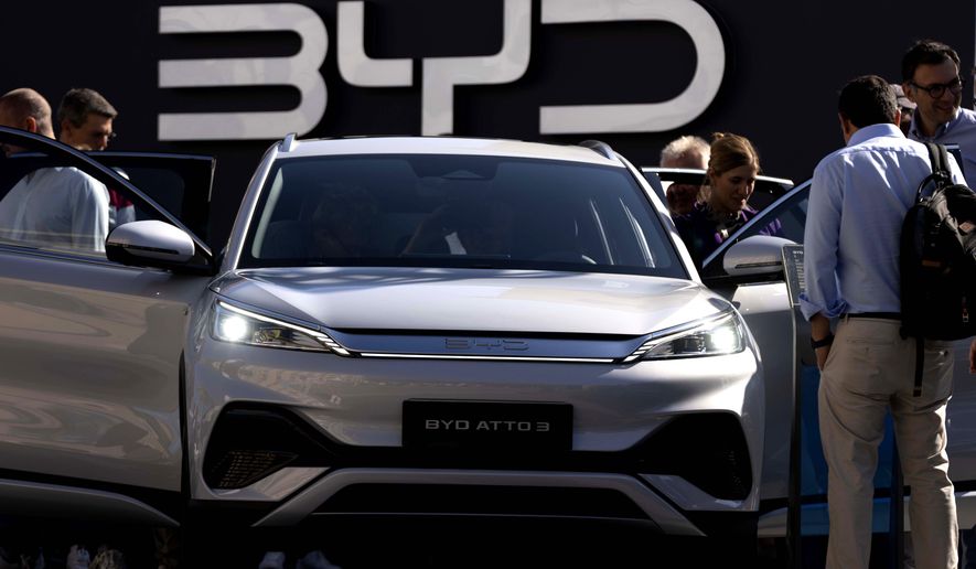 FILE - Visitors check the China made BYD ATTO 3 at the IAA motor show in Munich, Germany, on Sept. 8, 2023. The Chinese government has said it will take "all measures necessary to protect our legitimate rights and interests" in response to the tariffs on Chinese-made electric vehicles but it hasn't specified what those might be. (AP Photo/Matthias Schrader, File)