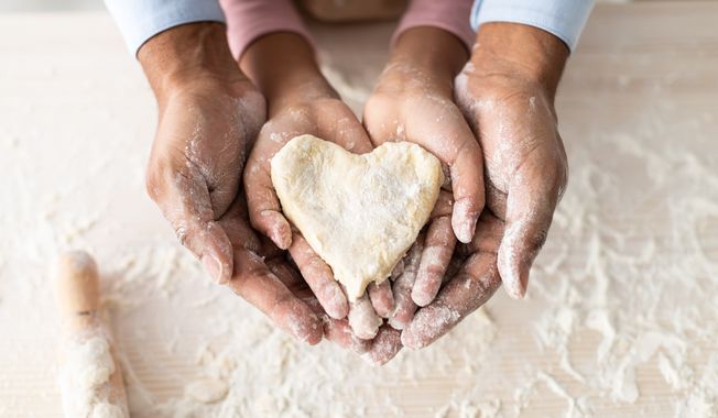 Father's Day, dad and daughter cooking together. File photo credit: Prostock-studio via Shutterstock.