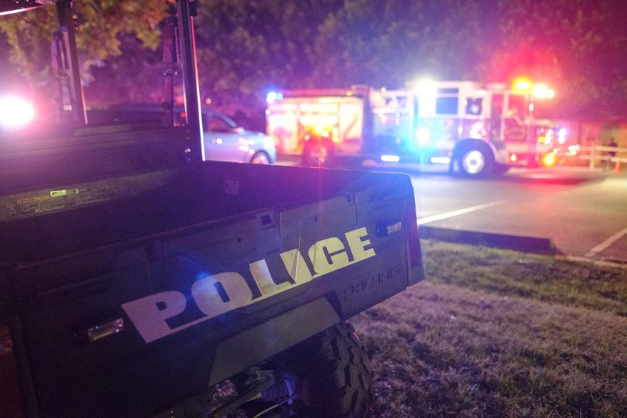 Vehicles from the Round Rock Police Department and Round Rock Fire Department sit parked after a fatal shooting during a Juneteenth celebration at Old Settlers Park in Round Rock, Texas, late Saturday, June 15, 2024. (Cross Harris/Austin American-Statesman via AP)