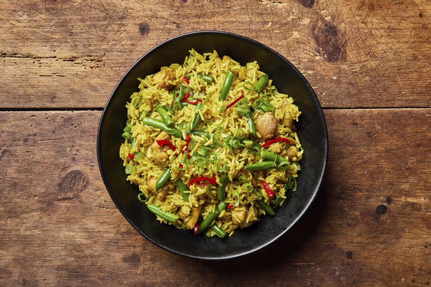 This image released by Milk Street shows a recipe for curried chicken fried rice. (Milk Street via AP)