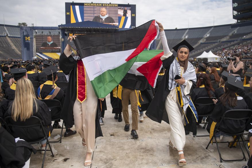Pro-Palestinian protesters demonstrate during the University of Michigan's Spring 2024 Commencement Ceremony at Michigan Stadium in Ann Arbor, Mich., May 4, 2024. The University of Michigan and the City University of New York didn't adequately investigate if campus protests in response to the Israel-Hamas war and other incidents created a hostile environment for students, faculty and staff. That's according to results of U.S. Education Department investigations announced Monday. (Katy Kildee/Detroit News via AP, File)