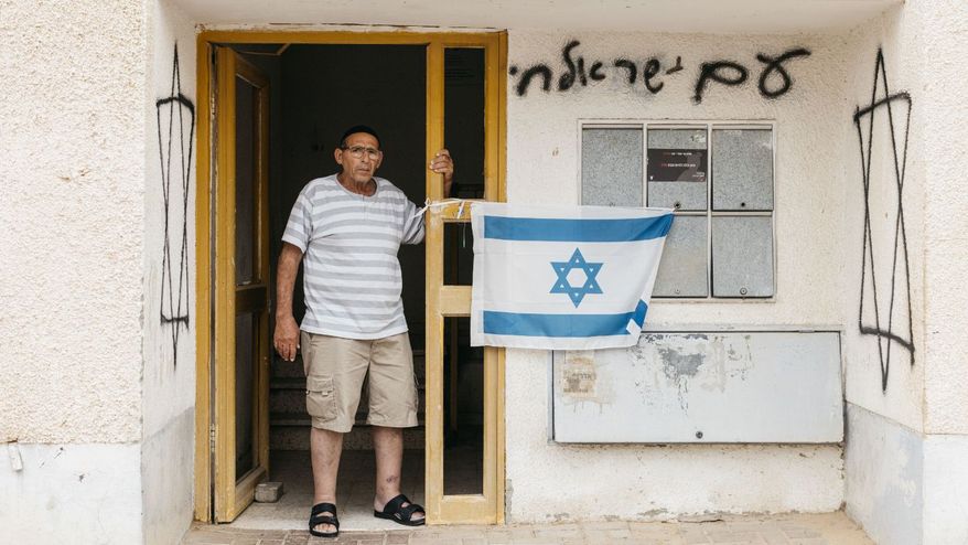 Shuki, a survivor of the October 7, 2023 attack on Israel, revisits the home he sheltered in. Photo Credit: The International Fellowship of Christians and Jews / Avishag Shaar-Yashuv.