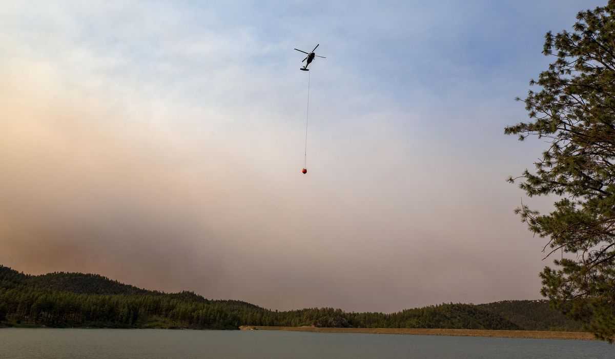 NextImg:Cooler temps and rain could help corral blazes that forced thousands to flee New Mexico village