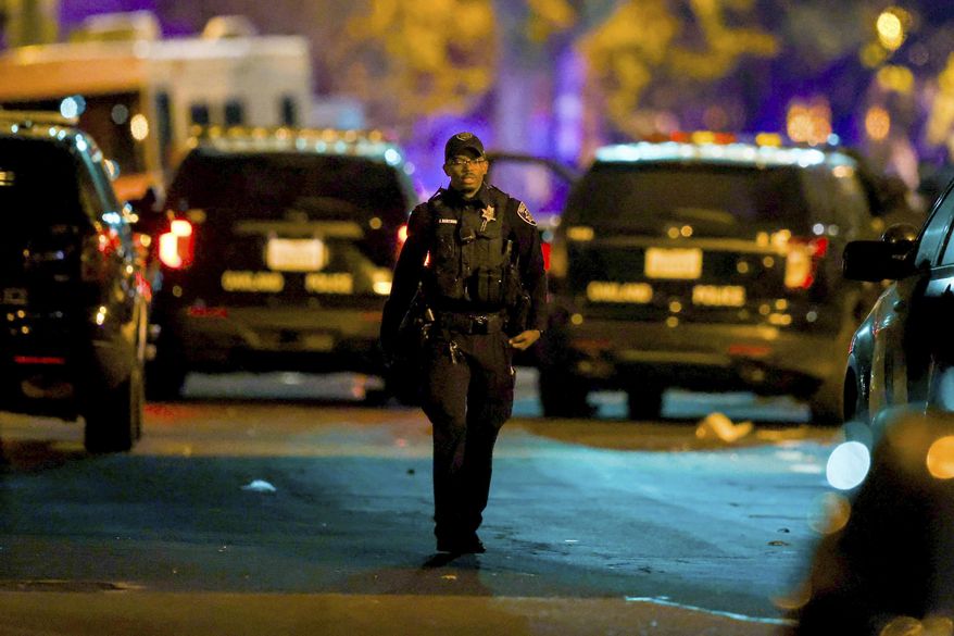 Oakland police officers respond to a multiple shooting during a Juneteenth celebration near Lake Merritt in Oakland, Calif., on Wednesday, June 19, 2024. A Juneteenth celebration in Oakland, California, turned violent when several people were shot, police said. (Ray Chavez /Bay Area News Group via AP)