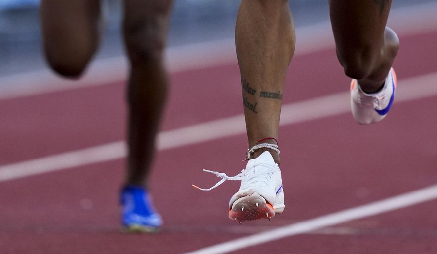 Sha'Carri Richardson wins a heat women's 100-meter run as her shoe appears to come untied during the U.S. Track and Field Olympic Team Trials Friday, June 21, 2024, in Eugene, Ore. (AP Photo/Charlie Neibergall)