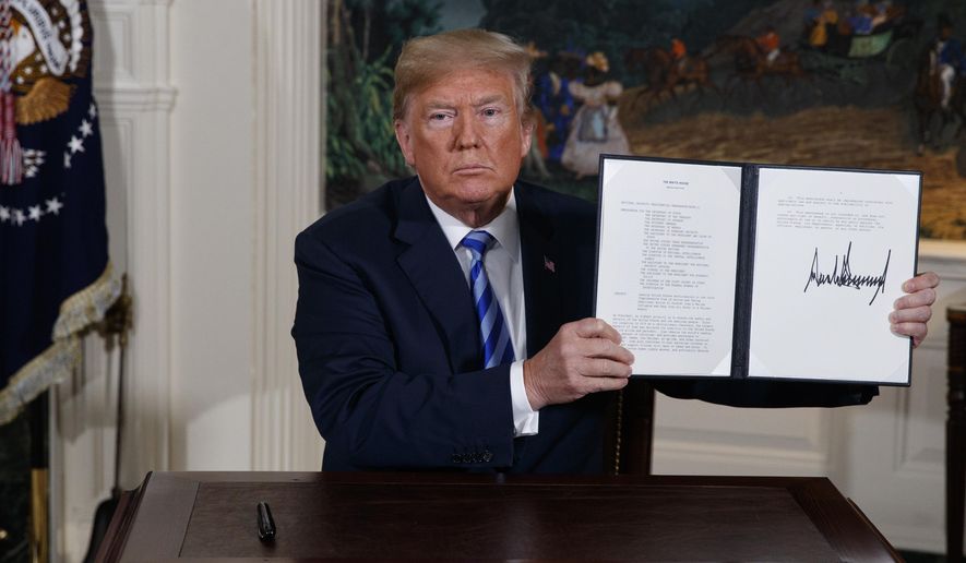 U.S. President Donald Trump shows a signed Presidential Memorandum after delivering a statement on the Iran nuclear deal from the Diplomatic Reception Room of the White House, on May 8, 2018. Iran will elect a new president Friday, June 28, 2024, after the death of hard-line President Ebrahim Raisi. Whoever takes the helm in the country will inherit Iran's rapidly advancing nuclear program, which now enriches uranium closer than ever to weapons-grade levels. (AP Photo/Evan Vucci, File)
