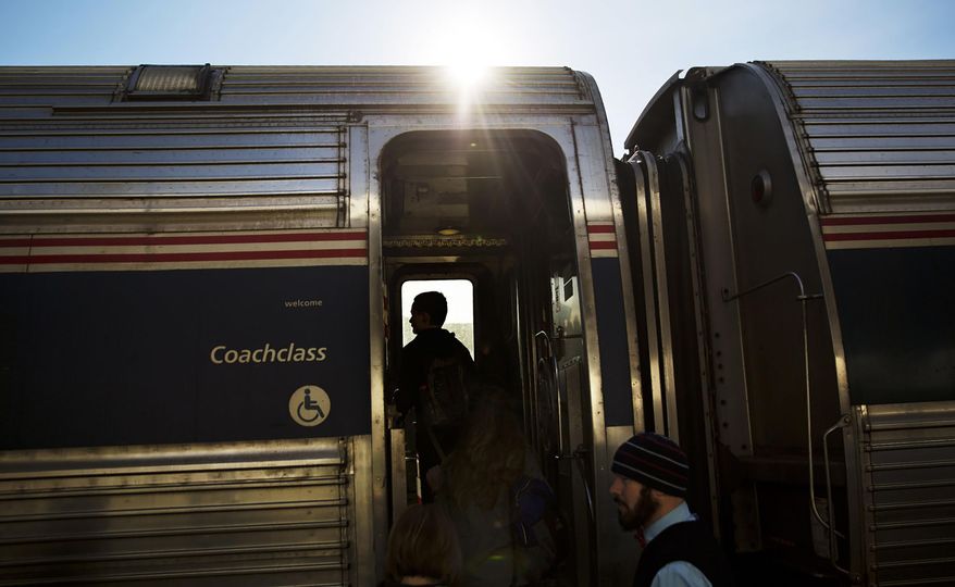 This file photo shows passengers boarding an Amtrak train heading to New Orleans from Atlanta on Nov. 23, 2016. (AP Photo/David Goldman, File)