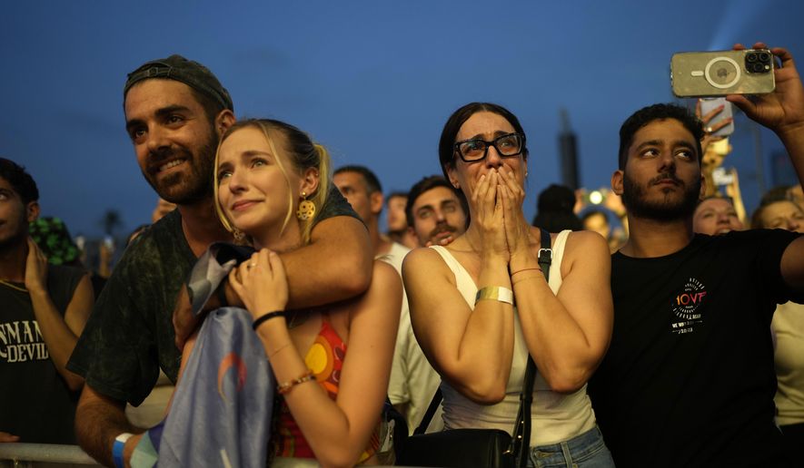 A woman weeps at the Nova Healing Concert in Tel Aviv, Israel, on Thursday, June 27, 2024. This was the first Tribe of Nova mass gathering since the Oct. 7, 2023 cross-border attack by Hamas that left hundreds at the Nova music festival dead or kidnapped to Gaza. (AP Photo/Ohad Zwigenberg)