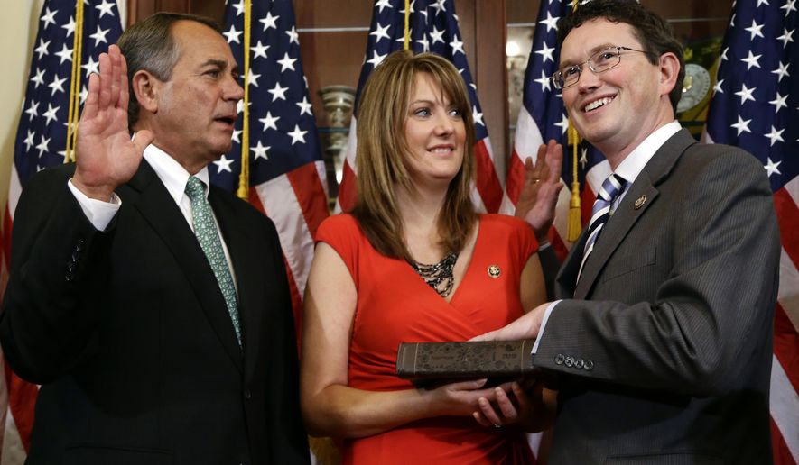 House Speaker John Boehner of Ohio, left, performs a mock swearing in for Rep. Thomas Massie, R-Ky., right, with his wife Rhonda Massie, center, on Capitol Hill Tuesday, Nov. 13, 2012, in Washington. Rhonda Massie, the wife of U.S. Rep. Thomas Massie, has died, the Kentucky congressman announced Friday, June 28, 2024, on social media. (AP Photo/Alex Brandon, File)
