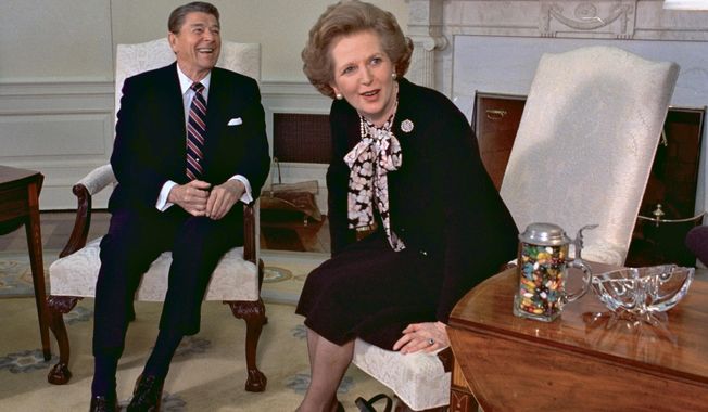 British Prime Minister Margaret Thatcher meets with US President Ronald Reagan at the White House in Washington, Feb. 20, 1985. (AP Photo/J. Scott Applewhite, File)