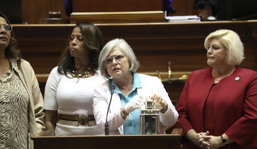 Four of South Carolina's Sister Senators, from left to right, Sen. Margie Bright Matthews, D-Walterboro, Sen. Mia McLeod, I-Columbia, Sen. Katrina Shealy, R-Lexington, and Sen. Penry Gustafson, R-Camden, stand in front of the Senate with their John F. Kennedy Profile in Courage award on Wednesday, June 26, 2024, in Columbia, S.C. The three Republican women Sister Senators were all voted out in their party's primary. (AP Photo/Jeffrey Collins)