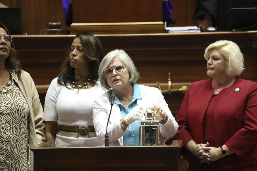 Four of South Carolina's Sister Senators, from left to right, Sen. Margie Bright Matthews, D-Walterboro, Sen. Mia McLeod, I-Columbia, Sen. Katrina Shealy, R-Lexington, and Sen. Penry Gustafson, R-Camden, stand in front of the Senate with their John F. Kennedy Profile in Courage award on Wednesday, June 26, 2024, in Columbia, S.C. The three Republican women Sister Senators were all voted out in their party's primary. (AP Photo/Jeffrey Collins)