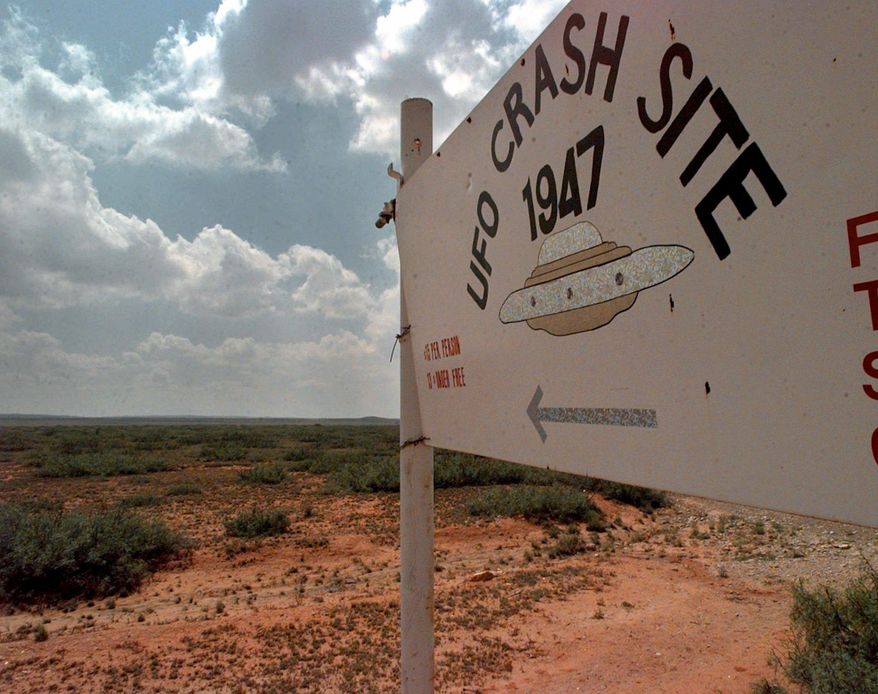 A sign directs travelers to the start of the "1947 UFO Crash Site Tours" in Roswell, N.M., June 10, 1997. World UFO Day is being celebrated amid a surge in sightings and government studies on unidentified flying objects. Its date of July 2nd has its roots in the so-called Roswell incident on July 2, 1947. (AP Photo/Eric Draper, File)