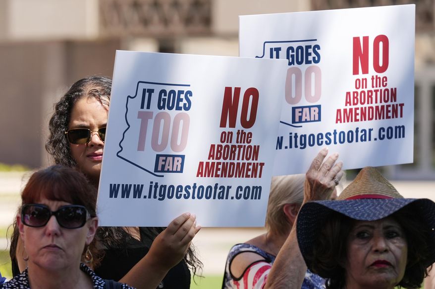 Anti-abortion protesters gather for a news conference after Arizona abortion-rights supporters deliver over 800,000 petition signatures to the capitol to get abortion rights on the November general election ballot Wednesday, July 3, 2024, in Phoenix. (AP Photo/Ross D. Franklin)