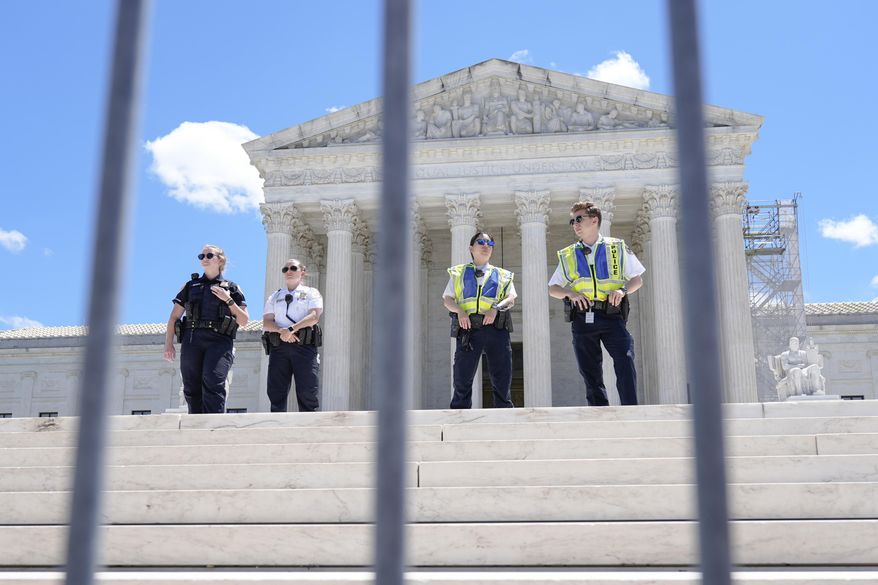 Supreme Court Police officers stand outside the Supreme Court Monday, July 1, 2024, in Washington. (AP Photo/Mariam Zuhaib)