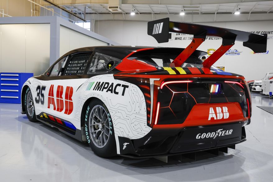 A prototype of the first electric racecar is displayed at the NASCAR R&D Center in Concord, N.C., Monday, July 1, 2024. The top motorsports series in North America partnered with Chevrolet, Ford, Toyota and electrification company ABB to demonstrate a high-performance electric vehicle and gauge fan interest in electric racing. (AP Photo/Nell Redmond)