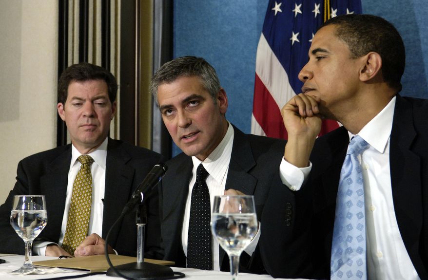 Academy Award winning actor George Clooney, center, flanked by then-Sen. Barack Obama, D-Ill., right, and Sen. Sam Brownback, R-Kan., takes part in a news conference at the National Press Club in Washington, Thursday, April 27, 2006 to bring awareness to the situation in the Darfur region of Sudan. (AP Photo/Mannie Garcia)