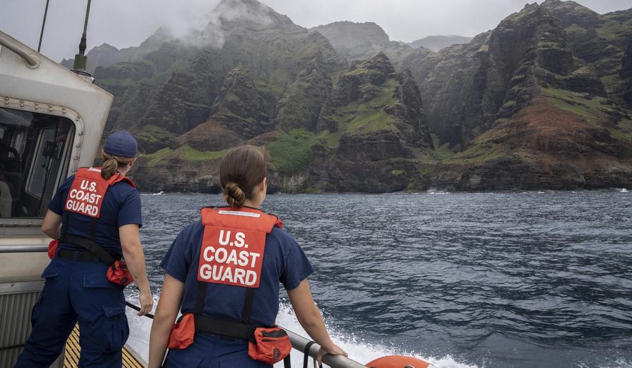 In this photo provided by the U.S. Coast Guard, coast guardsmen participate in a search after a helicopter crash near Na Pali Coast, Kauai, Hawaii. (Ty Robertson/USCG via AP) **FILE**