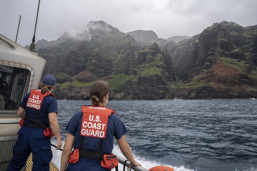 In this photo provided by the U.S. Coast Guard, coast guardsmen participate in a search after a helicopter crash near Na Pali Coast, Kauai, Hawaii. (Ty Robertson/USCG via AP) **FILE**