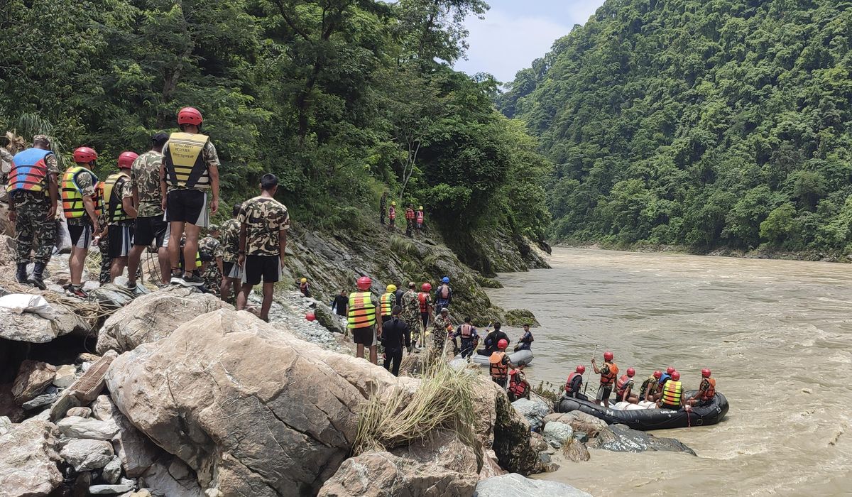 NextImg:Rescuers recover first body from 2 buses that were hit by landslide and fell into a river in Nepal