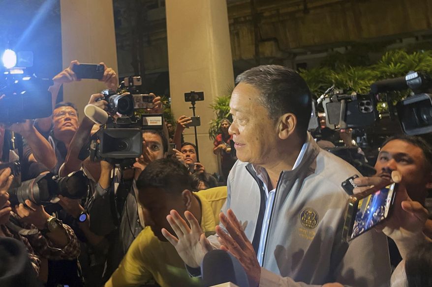 Thai Prime Minister Srettha Thavisin gestures as he is mobbed by the media upon arrival at Grand Hyatt Erawan in Bangkok, Thailand, Tuesday, July 16, 2024. Police said a number of people were found dead Tuesday in the luxury hotel in downtown Bangkok and poisoning is suspected. (AP Photo/Napat Kongsawad)