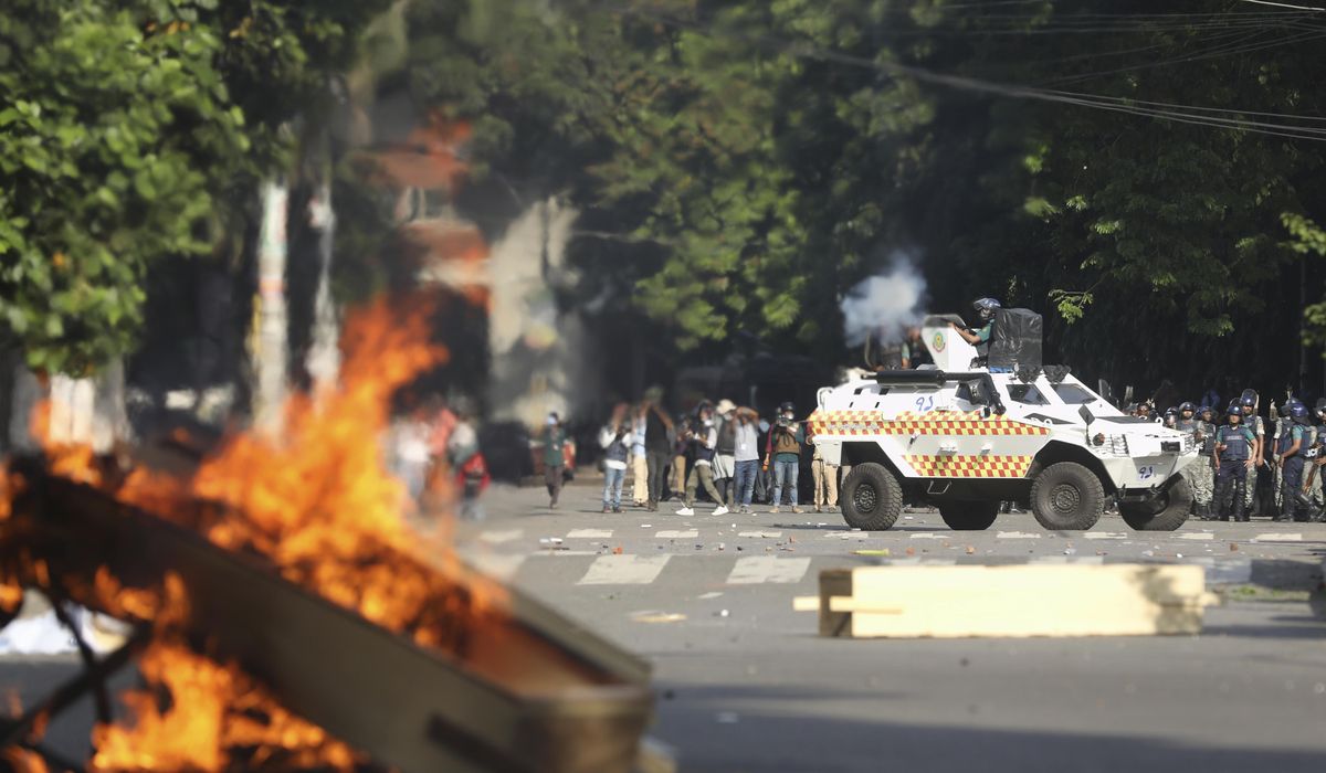 NextImg:Universities in Bangladesh shut their doors and authorities raid opposition HQ after deadly protests