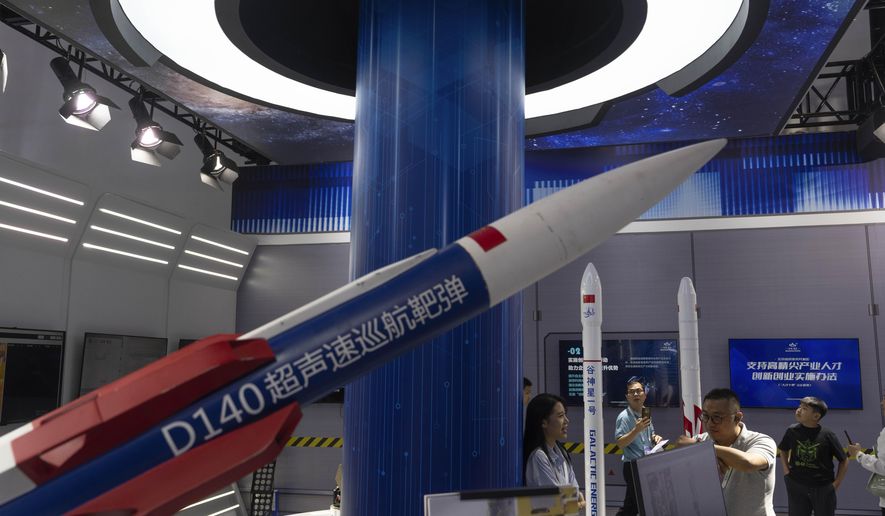 Visitors pass Chinese rocket technologies on display at the China Beijing International High-Tech Expo, promoting local technologies in Beijing, Tuesday, July 16, 2024. (AP Photo/Ng Han Guan) ** FILE **