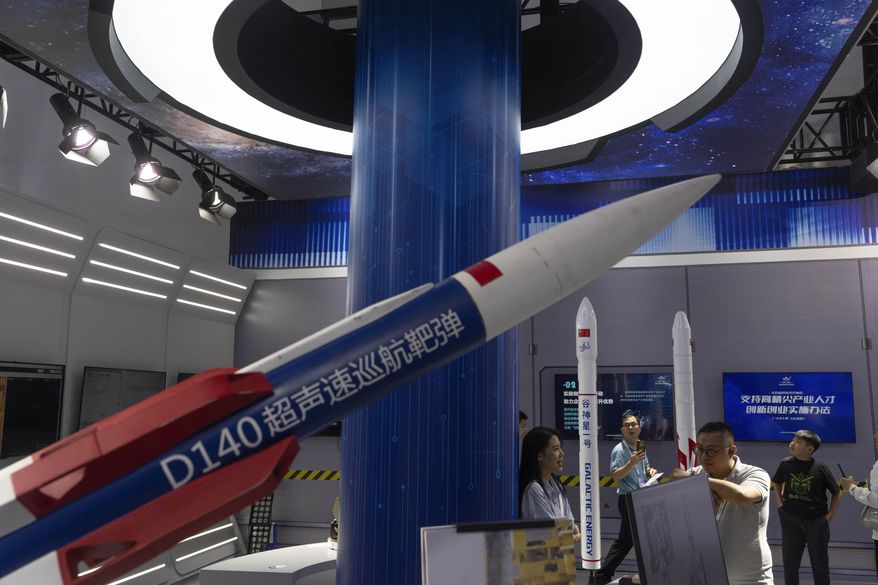 Visitors pass Chinese rocket technologies on display at the China Beijing International High-Tech Expo, promoting local technologies in Beijing, Tuesday, July 16, 2024. (AP Photo/Ng Han Guan) ** FILE **