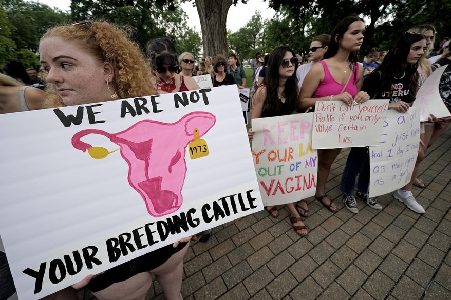 Abortion-rights advocates gather outside a the Kansas Statehouse in Topeka, Kan., to protest the U.S. Supreme Court's ruling on abortion, June 24, 2022. Kansas isn't enforcing a new law requiring abortion providers to ask patients why they want to terminate their pregnancies, as a legal challenge against that rule and other older requirements makes its way through the courts. (AP Photo/Charlie Riedel, File)