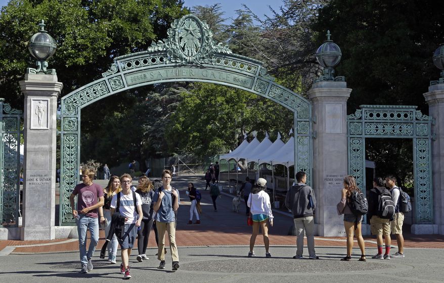 Students walk past Sather Gate on the University of California, Berkeley campus in Berkeley, Calif., April 21, 2017. The University of California Board of Regents voted Thursday, July 18, 2024, to ban employees from posting political statements on the homepages of university websites, saying such comments could be interpreted as the university system's official view. (AP Photo/Ben Margot, File)