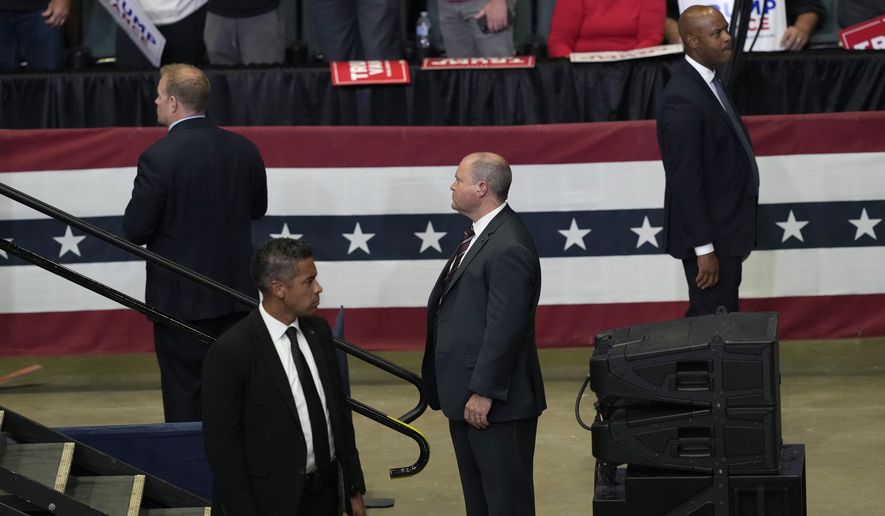 Members of the U.S. Secret Service look on as Republican presidential candidate former President Donald Trump speaks at a campaign event with Republican vice presidential candidate Sen. JD Vance, R-Ohio, Saturday, July 20, 2024, at Van Andel Arena in Grand Rapids, Mich. (AP Photo/Carlos Osorio)