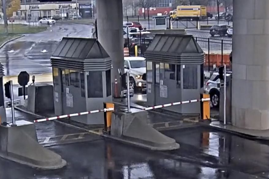 In this photo taken from security video, a light colored vehicle, top left, travels toward the Rainbow Bridge customs plaza, Nov. 22, 2023, in Niagara Falls, N.Y. The vehicle exploded at the checkpoint on the American side of a U.S.-Canada bridge, leaving two people dead and prompting the closing of four border crossings in the area, authorities said. (Customs Border Protection via AP, File)