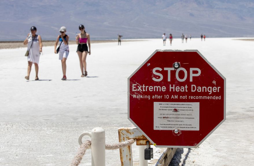 A stop sign warns tourists of extreme heat at Badwater Basin, Monday, July 8, 2024, in Death Valley National Park, Calif. (Daniel Jacobi II/Las Vegas Review-Journal via AP) ** FILE **