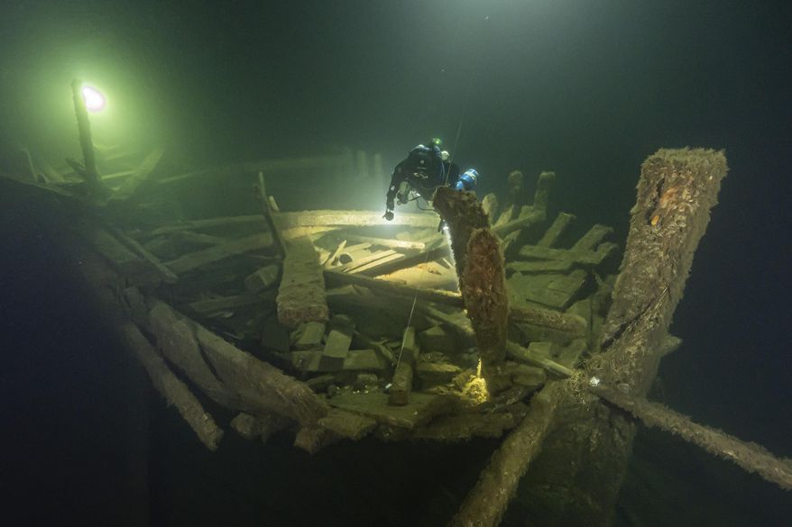 A diver from the Polish Baltictech team inspects wreckage of a 19th century sailing ship that the team discovered July 11, 2024, on the Baltic seabed about 37 kilometers (20 nautical miles) south of the Swedish isle of Öland. (Marek Cacaj/Baltictech via AP)