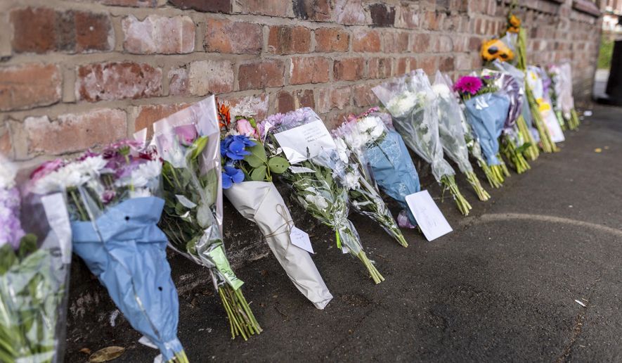Floral tributes near the scene in Hart Street, Southport, Britain, Tuesday July 30, 2024, where two children died and nine were injured in a "ferocious" knife attack during a Taylor Swift event at a dance school on Monday. A 17-year-old male from Banks, Lancashire, has been arrested on suspicion of murder and attempted murder over the incident. (James Speakman/PA via AP)