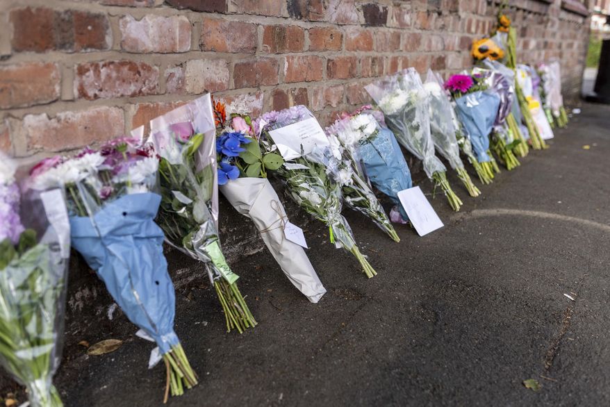 Floral tributes near the scene in Hart Street, Southport, Britain, Tuesday July 30, 2024, where two children died and nine were injured in a "ferocious" knife attack during a Taylor Swift event at a dance school on Monday. A 17-year-old male from Banks, Lancashire, has been arrested on suspicion of murder and attempted murder over the incident. (James Speakman/PA via AP)