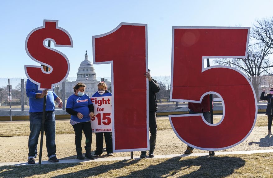 FILE - Activists appeal for a $15 minimum wage near the Capitol in Washington, Feb. 25, 2021. (AP Photo/J. Scott Applewhite, File)