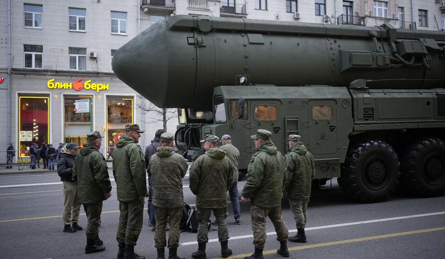 Soldiers stand next to a Russian RS-24 Yars ballistic missile parked along Tverskaya street prior to a rehearsal for the Victory Day military parade in Moscow, on May 2, 2024. Russia's nuclear doctrine says the country could use nuclear weapons in response to a nuclear strike or an attack with conventional weapons that threatens "the very existence" of the Russian state. (AP Photo/Alexander Zemlianichenko, File)