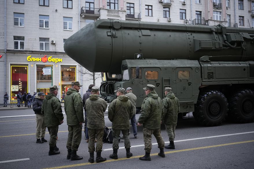 Soldiers stand next to a Russian RS-24 Yars ballistic missile parked along Tverskaya street prior to a rehearsal for the Victory Day military parade in Moscow, on May 2, 2024. Russia's nuclear doctrine says the country could use nuclear weapons in response to a nuclear strike or an attack with conventional weapons that threatens "the very existence" of the Russian state. (AP Photo/Alexander Zemlianichenko, File)