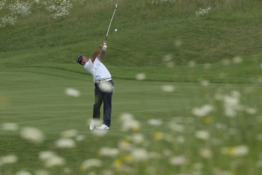 Hideki Matsuyama, of Japan, plays from the 3rd fairway during the second round of the men's golf event at the 2024 Summer Olympics, Friday, Aug. 2, 2024, at Le Golf National in Saint-Quentin-en-Yvelines, France. (AP Photo/Matt York)