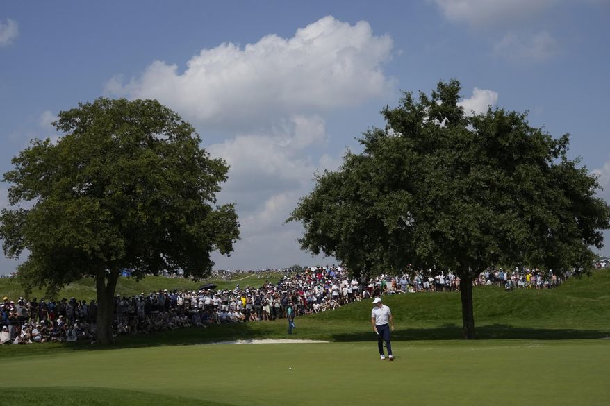 Rory McIlroy, of Ireland, looks at his putt on the 3rd green during the second round of the men's golf event at the 2024 Summer Olympics, Friday, Aug. 2, 2024, at Le Golf National in Saint-Quentin-en-Yvelines, France. (AP Photo/Matt York)
