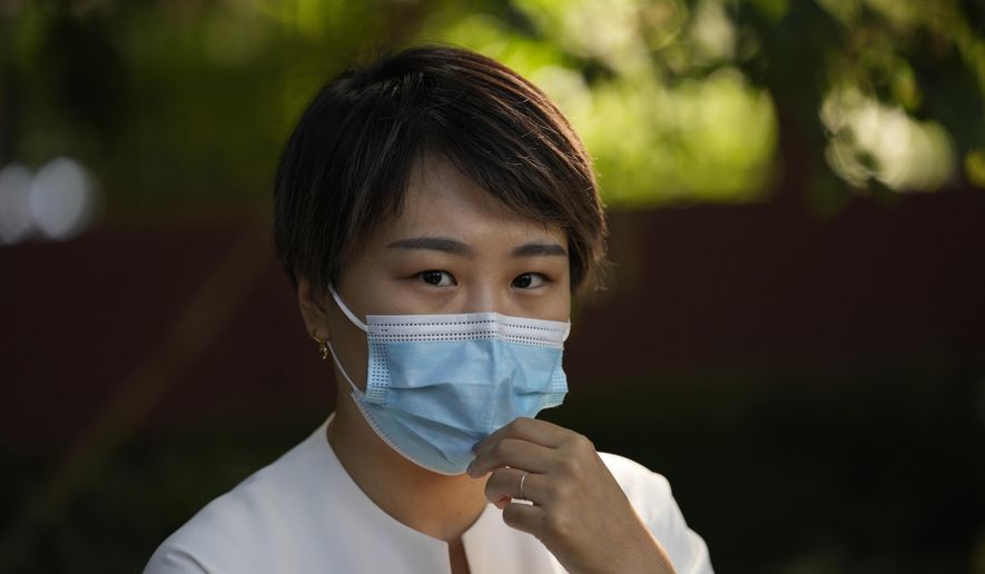 FILE - Teresa Xu, an unmarried woman suing for the right to freeze her eggs, prepares to attend a court session at the Chaoyang People's Court in Beijing, on Sept. 17, 2021. (AP Photo/Ng Han Guan, File)